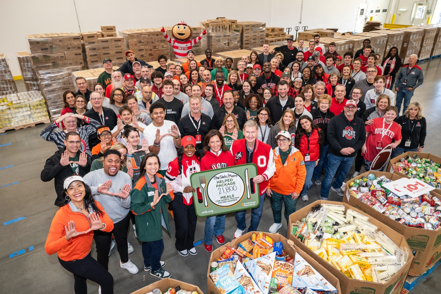 Ohio State and Miami worked together for a community service project today benefiting the North Texas Food Bank