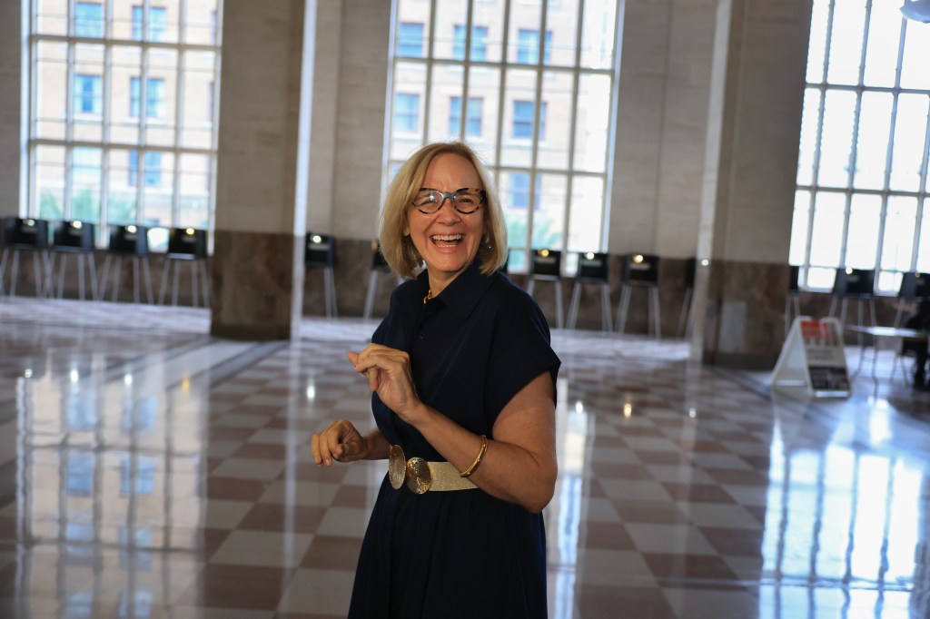 Miami Mayoral candidate Eileen Higgins laughing while voting at a polling place.