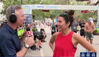 WESH 2ers cross finish line at OUC Orlando Half Marathon