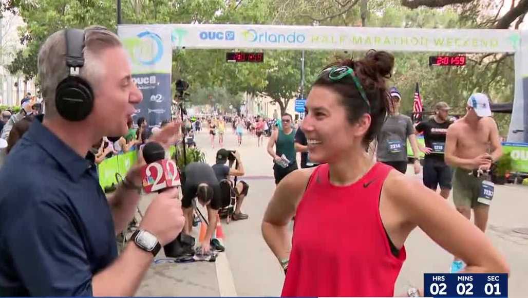 WESH 2ers cross finish line at OUC Orlando Half Marathon