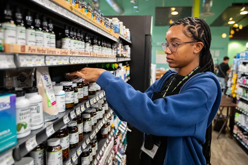 Keyallah Majeed, assistant wellness manager and community outreach lead at Community Co-op Market, restocks the wellness section Friday, Feb. 9, 2024.