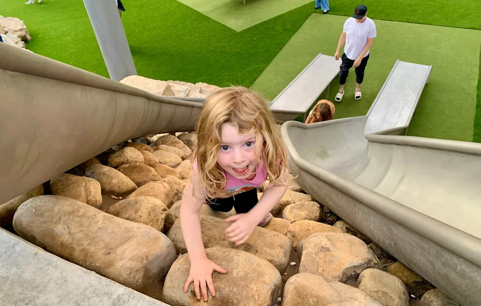 Madison Mancuso, 4, climbs up the sloping path to a higher level at the Riverfront Plaza playground on Dec. 5, 2025 in downtown Jacksonville, The park opened on the former site of the Jacksonville Landing.