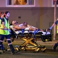 A wounded man is stretchered to hospital after the Bondi Beach shootings | News