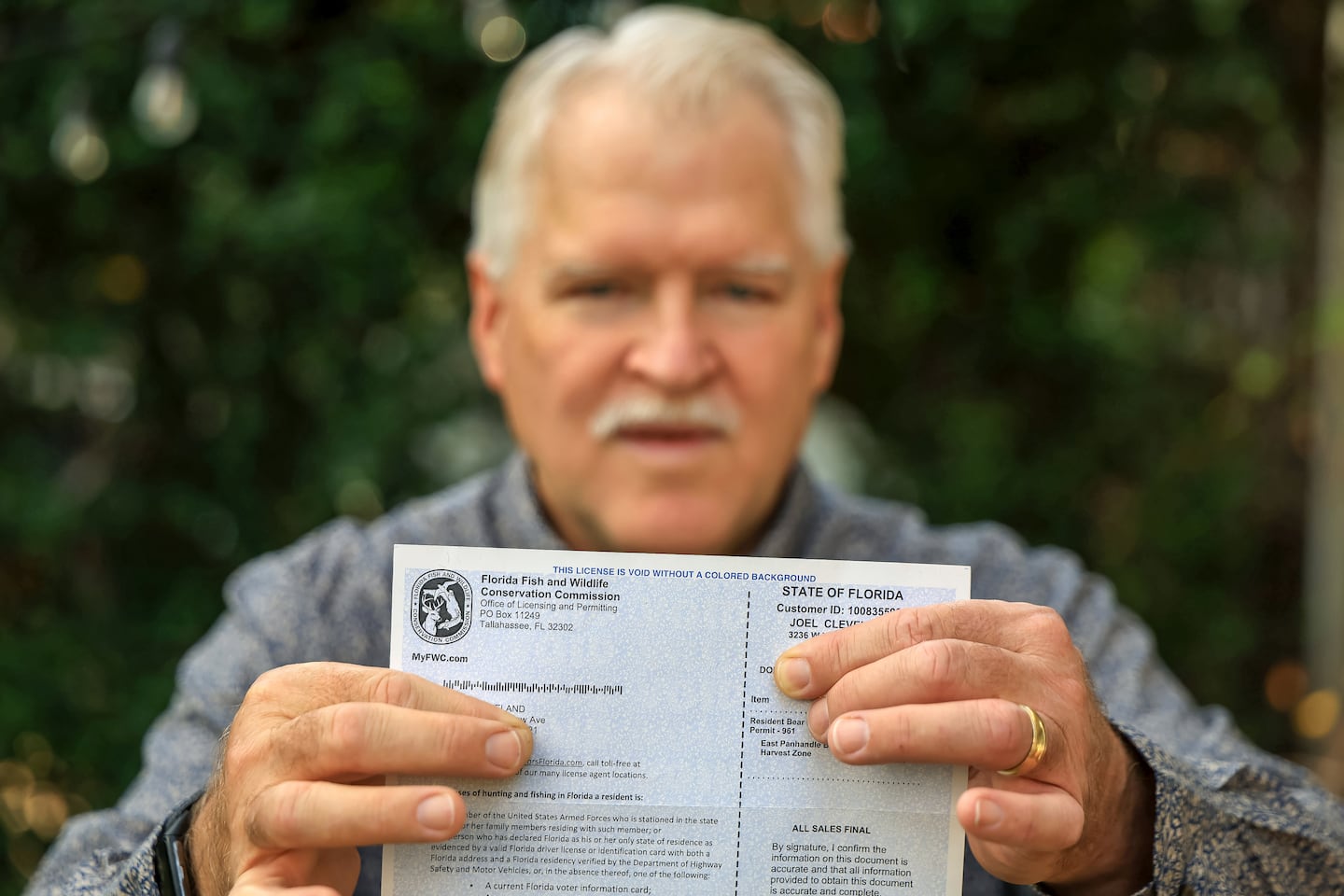 Joel Cleveland poses with his Florida bear hunting permit on Dec. 5 in Tampa, Fla.