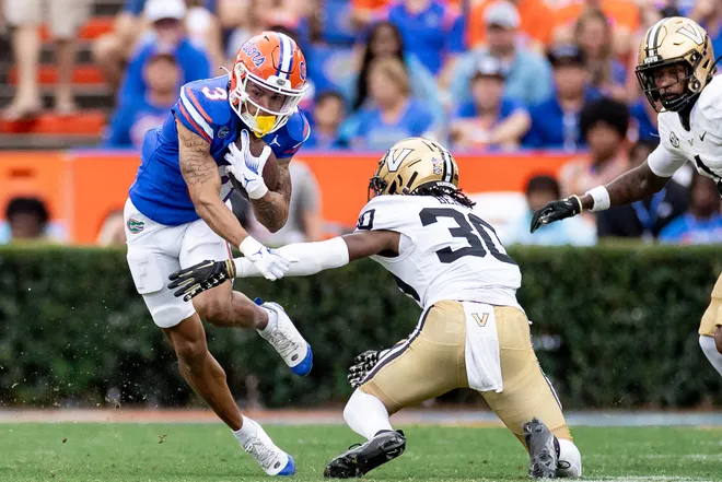 Florida Gators wide receiver Eugene Wilson III (3) breaks a tackle from Vanderbilt Commodores cornerback Trudell Berry (30) during the first half at Steve Spurrier Field at Ben Hill Griffin Stadium in Gainesville, FL on Saturday, October 7, 2023. [Matt Pendleton/Gainesville Sun]