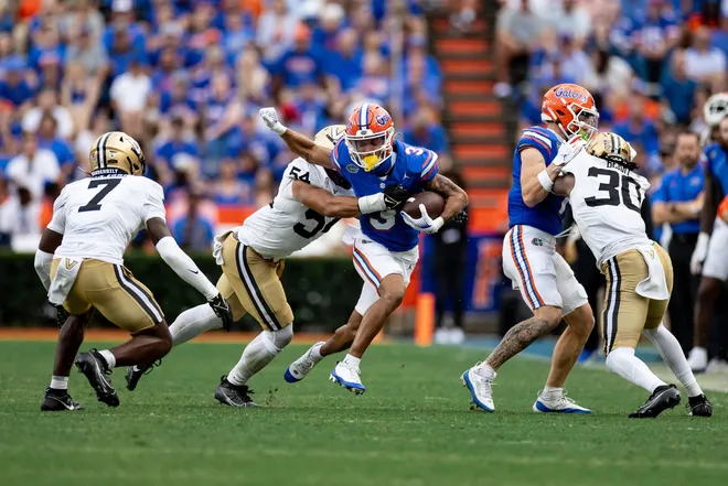 Florida Gators wide receiver Eugene Wilson III (3) runs through a tackle from Vanderbilt Commodores linebacker Bryan Longwell (54) during the second half at Steve Spurrier Field at Ben Hill Griffin Stadium in Gainesville, FL on Saturday, October 7, 2023. [Matt Pendleton/Gainesville Sun]