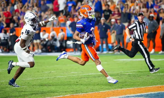 Florida Gators wide receiver Eugene Wilson III (3) runs for a touchdown as he looks back to Samford Bulldogs cornerback Kamron Smith (16) during the second half to make it 38-7 after the extra point at Ben Hill Griffin Stadium in Gainesville, FL on Saturday, September 7, 2024 against the Samford Bulldogs. The Florida Gators won 45-7 over the Bulldogs. [Doug Engle/Gainesville Sun]