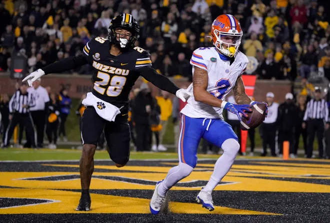COLUMBIA, MISSOURI - NOVEMBER 18: Wide receiver Eugene Wilson III #3 of the Florida Gators catches a pass for a touchdown against defensive back Joseph Charleston #28 of the Missouri Tigers in the first half at Faurot Field/Memorial Stadium on November 18, 2023 in Columbia, Missouri. (Photo by Ed Zurga/Getty Images)
