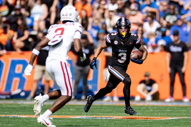 Florida Gators wide receiver Eugene Wilson III (3) runs with the ball towards Arkansas Razorbacks defensive back Dwight McGlothern (2) during the first half at Steve Spurrier Field at Ben Hill Griffin Stadium in Gainesville, FL on Saturday, November 4, 2023. [Matt Pendleton/Gainesville Sun]