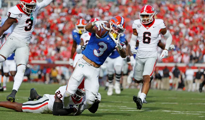 Oct 28, 2023; Jacksonville, Florida, USA; Florida Gators wide receiver Eugene Wilson III (3) dives in for a touchdown against Georgia Bulldogs defensive back Tykee Smith (23) in the first half at EverBank Stadium. Mandatory Credit: Jeff Swinger-USA TODAY Sports