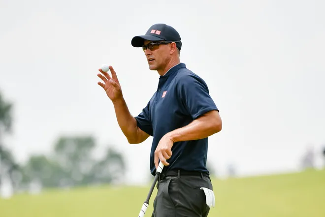 Adam Scott grabs the ball after sinking a putt during the second round of the 125th U.S. Open at Oakmont Country Club.