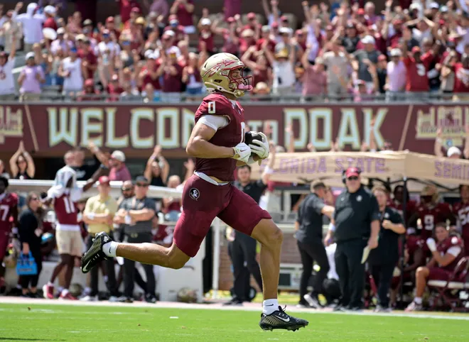 Sep 6, 2025; Tallahassee, Florida, USA; Florida State Seminoles wide receiver Duce Robinson (0) catches a touchdown during the first half against the East Texas A&M at Doak S. Campbell Stadium. Mandatory Credit: Melina Myers-Imagn Images