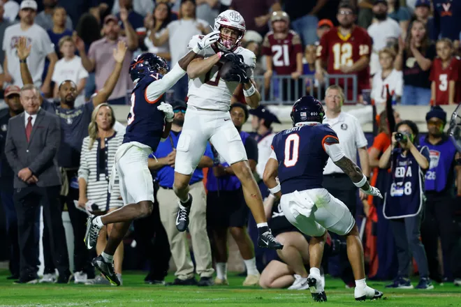 Sep 26, 2025; Charlottesville, Virginia, USA; Florida State Seminoles wide receiver Duce Robinson (0) catches a pass as Virginia Cavaliers cornerback Emmanuel Karnley (19) and Cavaliers safety Antonio Clary (0) defend during the second quarter at Scott Stadium. Mandatory Credit: Geoff Burke-Imagn Images