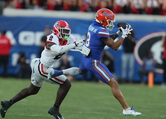 Florida Gators wide receiver Eugene Wilson III (3) grabs a pass with pressure from Georgia Bulldogs safety Zion Branch (2) during the second half of an NCAA football game at Everbank Stadium in Jacksonville, FL on Saturday, November 1, 2025. Georgia won 24-20. [Alan Youngblood/Gainesville Sun]