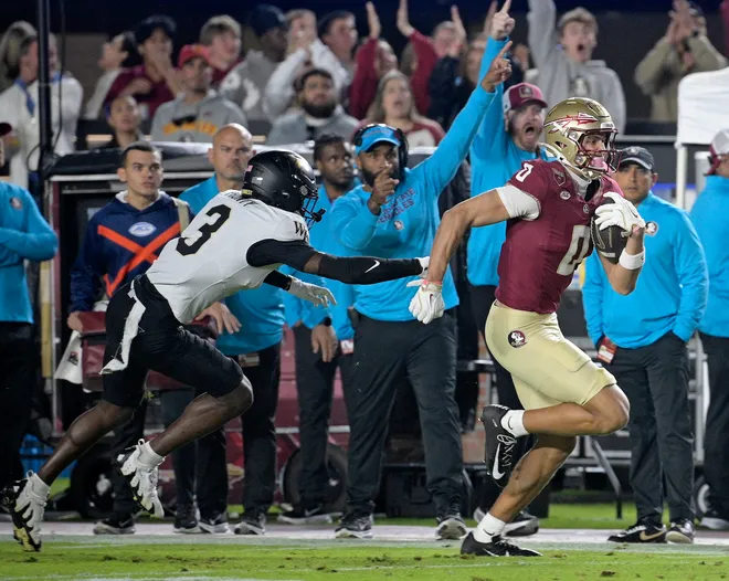 Nov 1, 2025; Tallahassee, Florida, USA; Florida State Seminoles wide receiver Duce Robinson (0) runs with the ball past the defense of Wake Forest Demon Deacons defensive back Karon Prunty (3) during the first quarter at Doak S. Campbell Stadium. Mandatory Credit: Melina Myers-Imagn Images