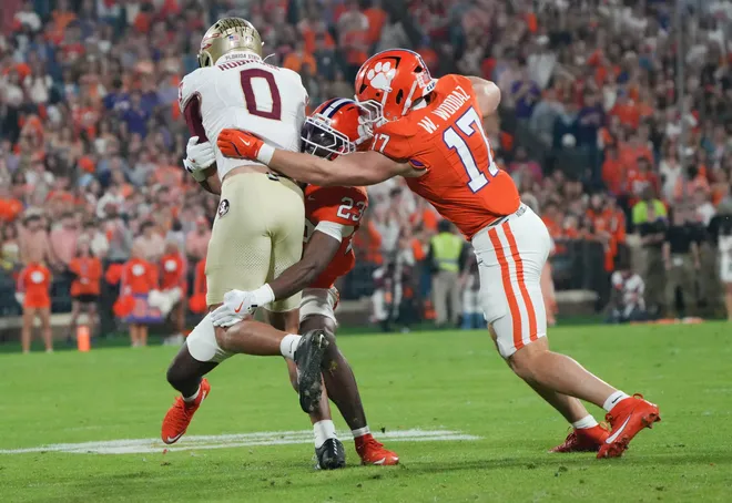 Florida State University receiver Duce Robinson (0) is tackled by Clemson cornerback Ashton Hampton (23) during the first quarter at Memorial Stadium in Clemson, S.C. Saturday, November 8, 2025.