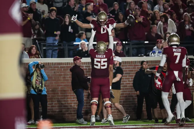 TALLAHASSEE, FLORIDA - NOVEMBER 15: Duce Robinson #0 and Gunnar Hansen #55 of the Florida State Seminoles celebrate after scoring a touchdown during the first half of a game against the Virginia Tech Hokies at Doak S. Campbell Stadium on November 15, 2025 in Tallahassee, Florida. (Photo by James Gilbert/Getty Images)