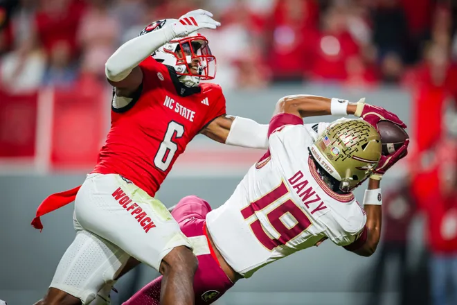 RALEIGH, NORTH CAROLINA - NOVEMBER 21: Devon Marshall #6 of the NC State Wolfpack defends a pass to Micahi Danzy #19 of the Florida State Seminoles during the first half of a football game at Carter-Finley Stadium on November 21, 2025 in Raleigh, North Carolina. (Photo by David Jensen/Getty Images)