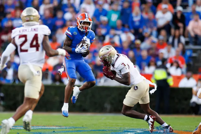 Nov 29, 2025; Gainesville, Florida, USA; Florida Gators wide receiver Eugene Wilson III (3) makes a catch over Florida State Seminoles defensive back Edwin Joseph (3) during the first half at Ben Hill Griffin Stadium. Mandatory Credit: Matt Pendleton-Imagn Images
