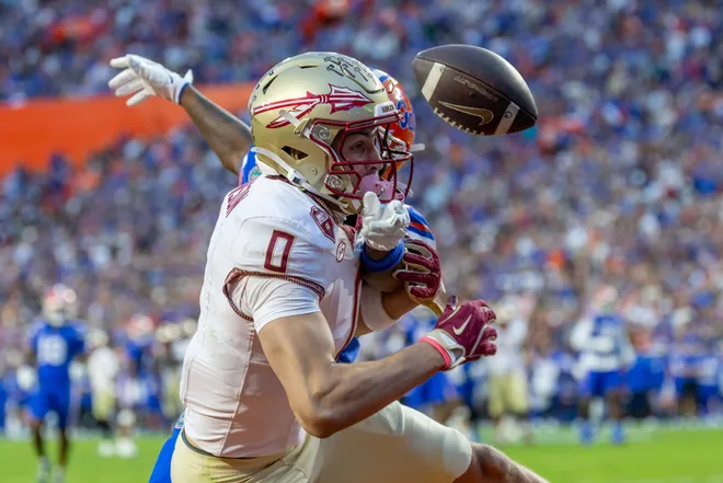 Nov 29, 2025; Gainesville, Florida, USA; Florida State Seminoles wide receiver Duce Robinson (0) drops the ball during the second quarter against the Florida Gators at Ben Hill Griffin Stadium. Mandatory Credit: Bob Kupbens-Imagn Images