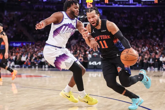 Dec 5, 2025; New York, New York, USA; New York Knicks guard Jalen Brunson (11) looks to drive past Utah Jazz guard Isaiah Collier (8) in the third quarter at Madison Square Garden.