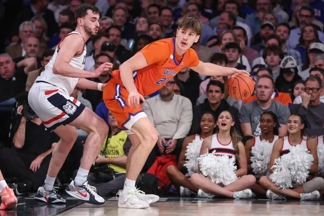 Dec 9, 2025; New York, New York, USA; Florida Gators forward Alex Condon (21) looks to post up against UConn Huskies forward Alex Karaban (11) in the first half at Madison Square Garden. Mandatory Credit: Wendell Cruz-Imagn Images