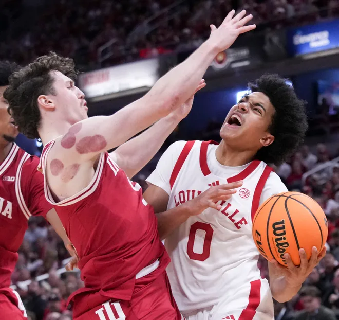 Louisville Cardinals guard Mikel Brown Jr. (0) attempts to get past Indiana Hoosiers guard Conor Enright (5) during a game Saturday, Dec. 6, 2025, at Gainbridge Fieldhouse in Indianapolis. Louisville defeated Indiana 87-78.