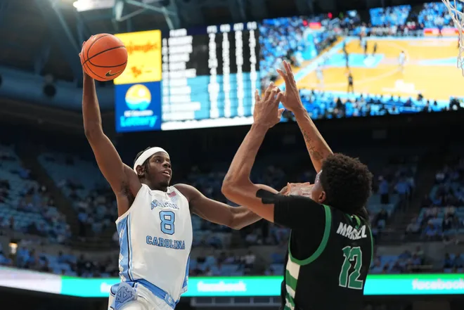 Dec 13, 2025; Chapel Hill, North Carolina, USA; North Carolina Tar Heels forward Caleb Wilson (8) shoots as USC Upstate Spartans forward Jafeth Martinez (12) defends in the second half at Dean E. Smith Center. Mandatory Credit: Bob Donnan-Imagn Images
