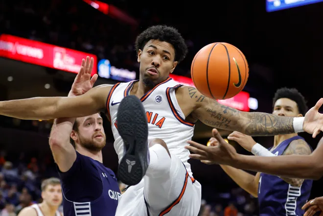 Nov 28, 2025; Charlottesville, Virginia, USA; Virginia Cavaliers guard Malik Thomas (1) battles for the ball against the Queens University of Charlotte Royals during the second half at John Paul Jones Arena. Mandatory Credit: Amber Searls-Imagn Images