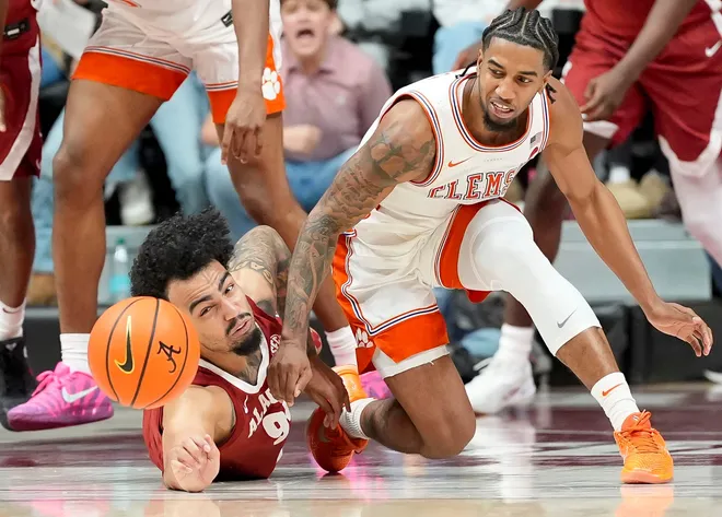 Dec 3, 2025; Tuscaloosa, AL, USA; Alabama guard Houston Mallette (95) fights for the ball on the floor with Clemson guard Dillon Hunter (2) at Coleman Coliseum. Alabama defeated Clemson 90-84. Mandatory Credit: Gary Cosby Jr.-Tuscaloosa News
