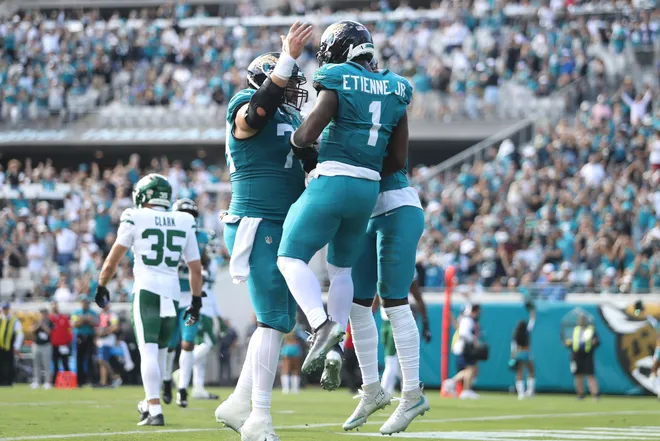 Dec 14, 2025; Jacksonville, Florida, USA; Jacksonville Jaguars running back Travis Etienne Jr. (1) reacts after scoring a touchdown during the second quarter against the New York Jets at EverBank Stadium. Mandatory Credit: Morgan Tencza-Imagn Images