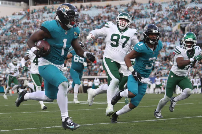 Dec 14, 2025; Jacksonville, Florida, USA; Jacksonville Jaguars running back Travis Etienne Jr. (1) runs to score a touchdown during the fourth quarter against the New York Jets at EverBank Stadium. Mandatory Credit: Morgan Tencza-Imagn Images