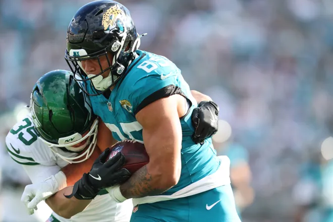 Dec 14, 2025; Jacksonville, Florida, USA; New York Jets safety Dean Clark (35) tackles Jacksonville Jaguars tight end Brenton Strange (85) during the third quarter at EverBank Stadium. Mandatory Credit: Morgan Tencza-Imagn Images