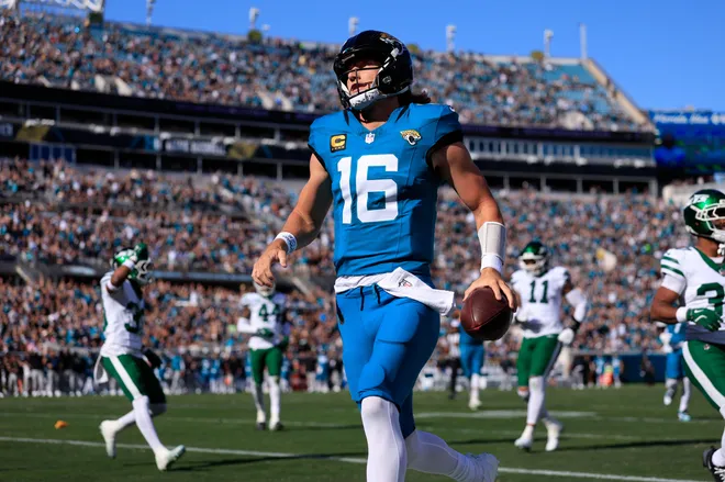 Jacksonville Jaguars quarterback Trevor Lawrence (16) scores a touchdown on a keeper during the first quarter of an NFL football matchup at EverBank Stadium, Sunday, Dec. 14, 2025, in Jacksonville, Fla. [Corey Perrine/Florida Times-Union]