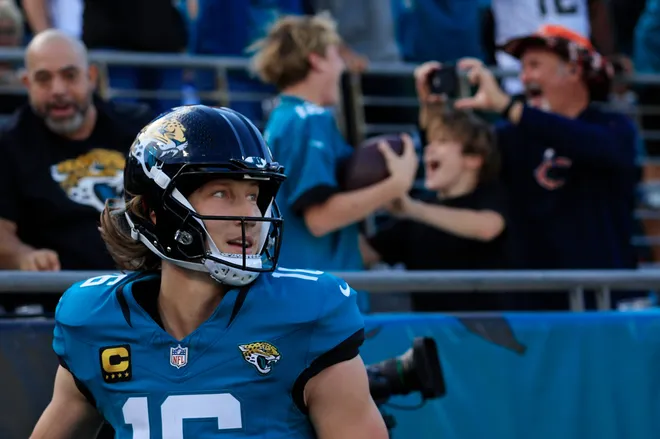 Jacksonville Jaguars quarterback Trevor Lawrence (16) looks on after scoring a touchdown and giving the ball to a young fan during the first quarter of an NFL football matchup at EverBank Stadium, Sunday, Dec. 14, 2025, in Jacksonville, Fla. [Corey Perrine/Florida Times-Union]