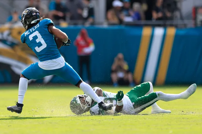 Jacksonville Jaguars wide receiver Jakobi Meyers (3) is tackled by New York Jets cornerback Jordan Clark (33) during the second quarter of an NFL football matchup at EverBank Stadium, Sunday, Dec. 14, 2025, in Jacksonville, Fla. [Corey Perrine/Florida Times-Union]