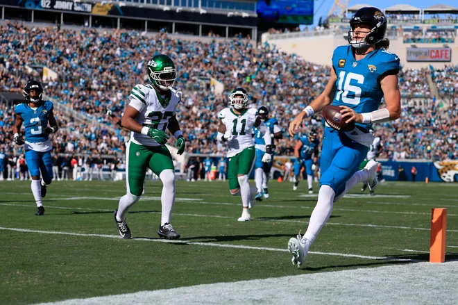 Jacksonville Jaguars quarterback Trevor Lawrence (16) scores a touchdown on a keeper during the first quarter of an NFL football matchup at EverBank Stadium, Sunday, Dec. 14, 2025, in Jacksonville, Fla. [Corey Perrine/Florida Times-Union]
