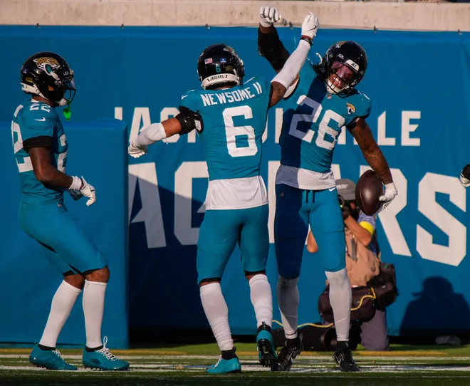 Jacksonville Jaguars safety Antonio Johnson (26) celebrates his fourth quarter interception with Jacksonville Jaguars cornerback Greg Newsome II (6) during an NFL football game at EverBank Stadium, Sunday, Dec. 14, 2025, in Jacksonville, Fla. The Jaguars defeated the Jets 48-20. [Doug Engle/Florida Times-Union]