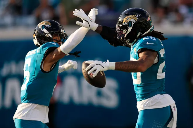 Jacksonville Jaguars safety Antonio Johnson (26), right, celebates his interception with cornerback Greg Newsome II (6) during the fourth quarter of an NFL football matchup at EverBank Stadium, Sunday, Dec. 14, 2025, in Jacksonville, Fla. The Jaguars defeated the Jets 48-20. [Corey Perrine/Florida Times-Union]