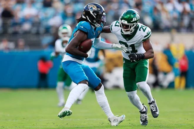 Jacksonville Jaguars wide receiver Brian Thomas Jr. (7) hauls in a reception against New York Jets cornerback Brandon Stephens (21) during the third quarter of a NFL football matchup at EverBank Stadium, Sunday, Dec. 14, 2025, in Jacksonville, Fla. The Jaguars defeated the Jets 48-20. [Corey Perrine/Florida Times-Union]