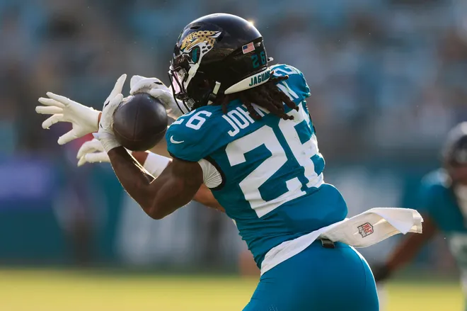 Jacksonville Jaguars safety Antonio Johnson (26) effectively end the game on an interception against New York Jets wide receiver Arian Smith (82) ends the during the fourth quarter of an NFL football matchup at EverBank Stadium, Sunday, Dec. 14, 2025, in Jacksonville, Fla. The Jaguars defeated the Jets 48-20. [Corey Perrine/Florida Times-Union]