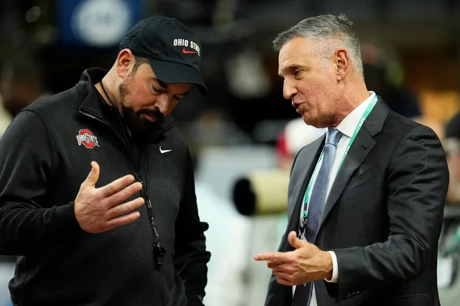 Ohio State Buckeyes head coach Ryan Day talks to Big Ten Conference commissioner Tony Petitti prior to the Big Ten Conference championship game against the Indiana Hoosiers at Lucas Oil Stadium in Indianapolis on Dec. 6, 2025. Ohio State lost 13-10.