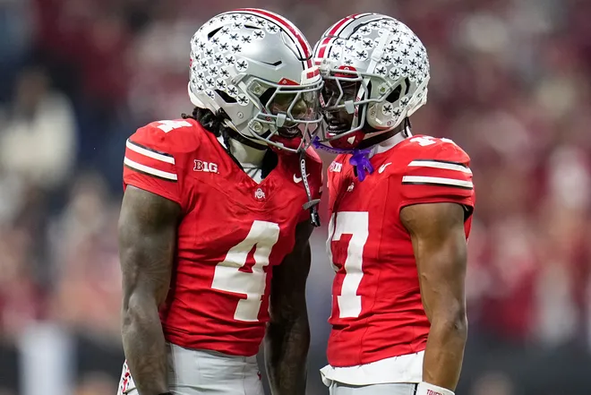 Ohio State Buckeyes wide receiver Jeremiah Smith (4) celebrates with wide receiver Carnell Tate (17) during the first half of the Big Ten championship game