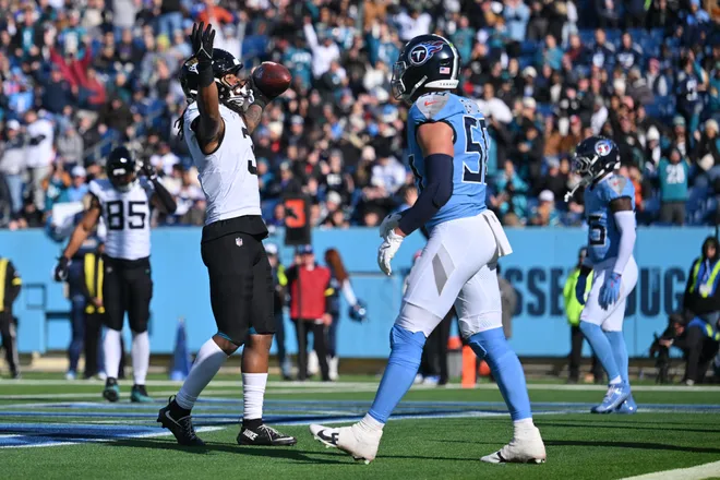 Nov 30, 2025; Nashville, Tennessee, USA; Jacksonville Jaguars wide receiver Jakobi Meyers (3) celebrate a touchdown catch as Tennessee Titans linebacker Cody Barton (50) looks on during the first half at Nissan Stadium. Mandatory Credit: Steve Roberts-Imagn Images