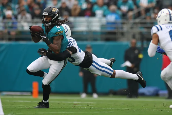 Dec 7, 2025; Jacksonville, Florida, USA; Jacksonville Jaguars wide receiver Jakobi Meyers (3) runs after the catch as Indianapolis Colts cornerback Jaylon Jones (40) defends during the first half at EverBank Stadium. Mandatory Credit: Matt Pendleton-Imagn Images