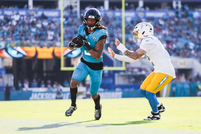 Nov 16, 2025; Jacksonville, Florida, USA; Jacksonville Jaguars wide receiver Jakobi Meyers (3) runs for yards after the catch against Los Angeles Chargers cornerback Elijah Molden (2) during the fourth quarter at EverBank Stadium. Mandatory Credit: Nathan Ray Seebeck-Imagn Images