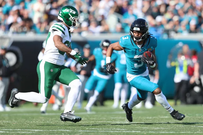 Dec 14, 2025; Jacksonville, Florida, USA; Jacksonville Jaguars wide receiver Jakobi Meyers (3) runs with the ball against New York Jets cornerback Qwan'Tez Stiggers (37) during the first quarter at EverBank Stadium. Mandatory Credit: Morgan Tencza-Imagn Images