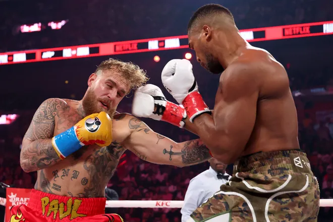 MIAMI, FLORIDA - DECEMBER 19: (R-L) Anthony Joshua punches Jake Paul during the heavyweight bout during Jake Paul v Anthony Joshua at Kaseya Center on December 19, 2025 in Miami, Florida. (Photo by Ed Mulholland/Getty Images for Netflix)