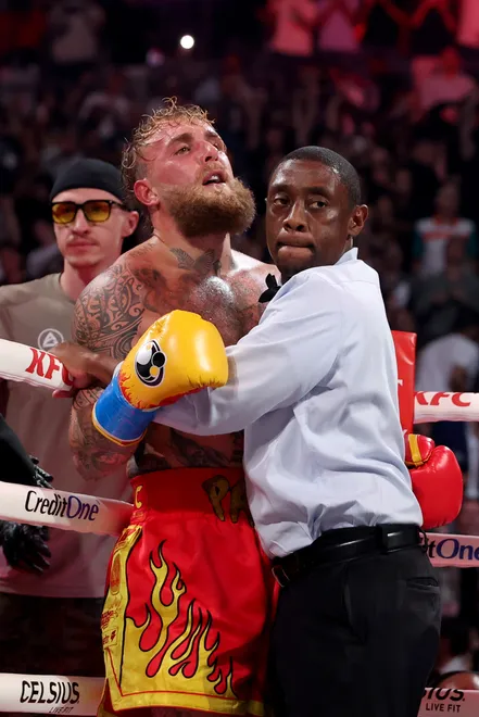 MIAMI, FLORIDA - DECEMBER 19: Jake Paul is held back by the referee against Anthony Joshua in their heavyweight bout during Jake Paul v Anthony Joshua at Kaseya Center on December 19, 2025 in Miami, Florida. (Photo by Ed Mulholland/Getty Images for Netflix)