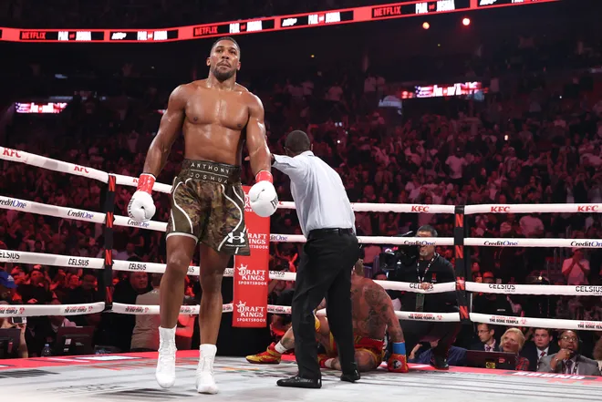 MIAMI, FLORIDA - DECEMBER 19: Jake Paul is knocked down against Anthony Joshua in their heavyweight bout Jake Paul v Anthony Joshua at Kaseya Center on December 19, 2025 in Miami, Florida. (Photo by Ed Mulholland/Getty Images for Netflix)